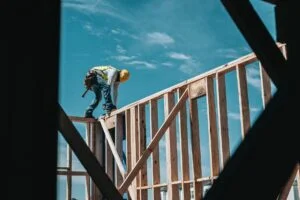Construction worker framing a house roof