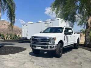 Patriot service truck beside a restroom trailer