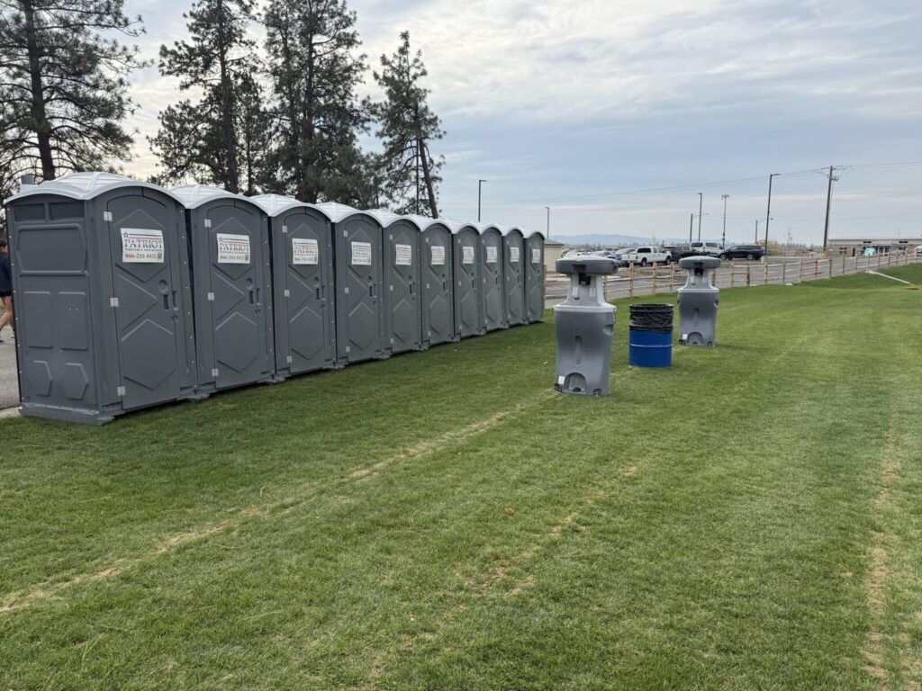Row of portable toilets staged on grass in Idaho