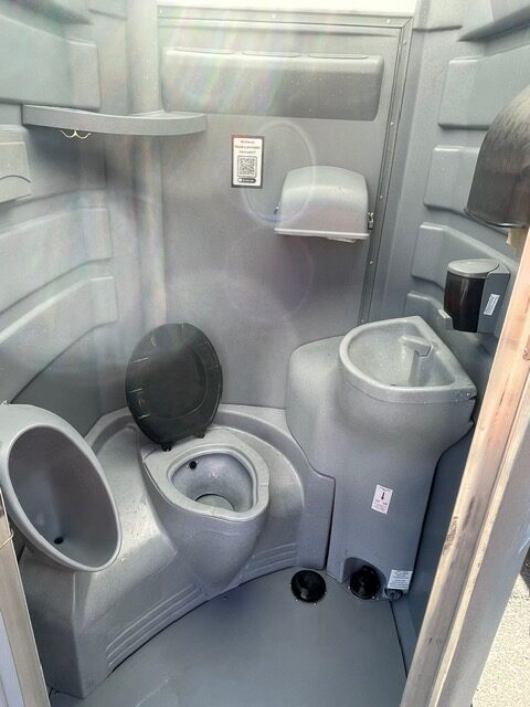 A picture of the interior of a flushable porta potty rental.
