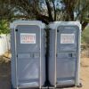 A picture of two flushable porta potty rentals side-by-side.