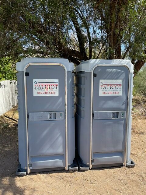 A picture of two flushable porta potty rentals side-by-side.