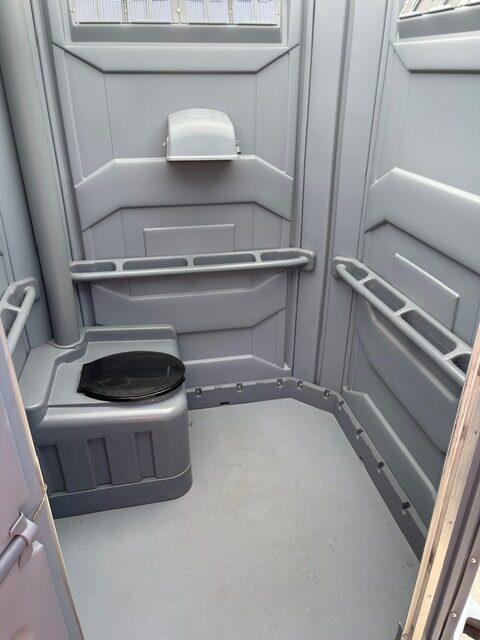 A picture of the interior of a wheelchair-accessible porta potty rental.