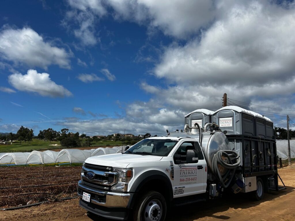 A picture of one of our delivery trucks bringing porta potties to the Carlsbad Flower Fields in San Diego, CA.