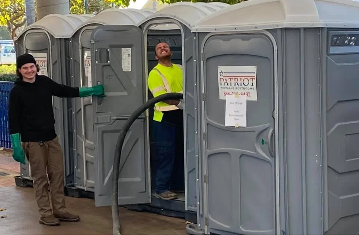 Patriot technician cleaning and servicing a portable toilet