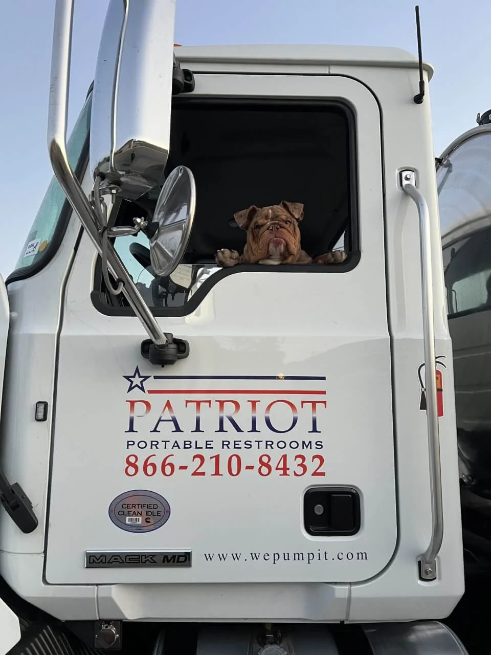 A picture of the side of the Patriot pump truck with a bulldog in the driver's seat.