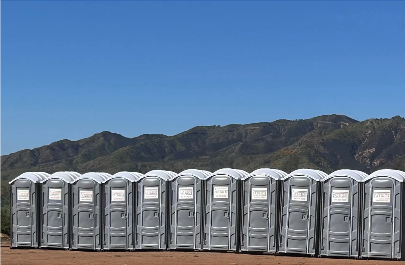 Row of portable toilets at a film location in the mountains
