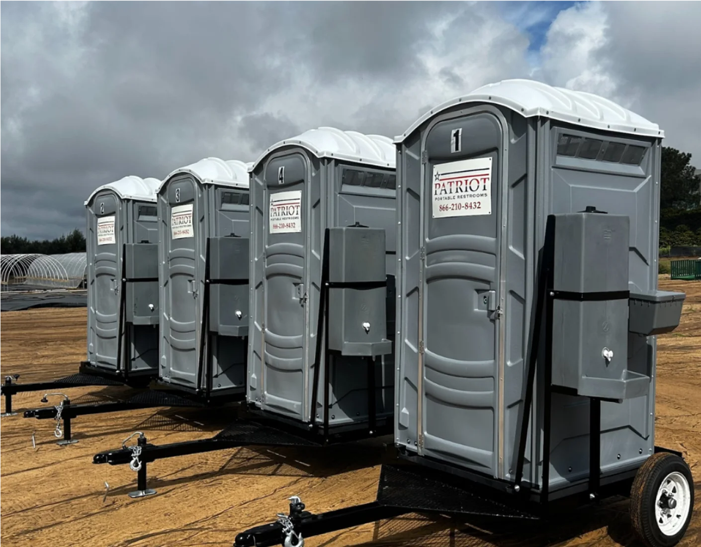 Row of Patriot portable toilets staged on a job site