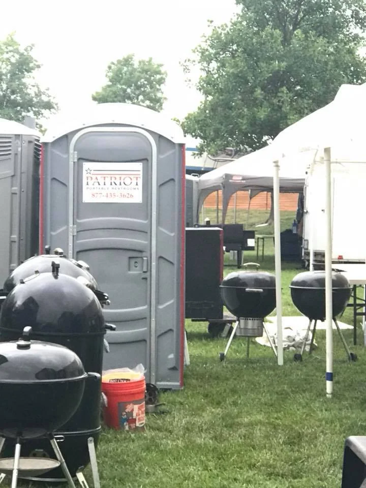 Patriot portable toilet beside a tent at a special event