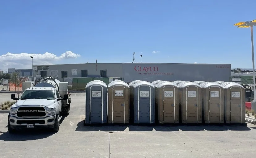 Row of portable toilets delivered to a construction site