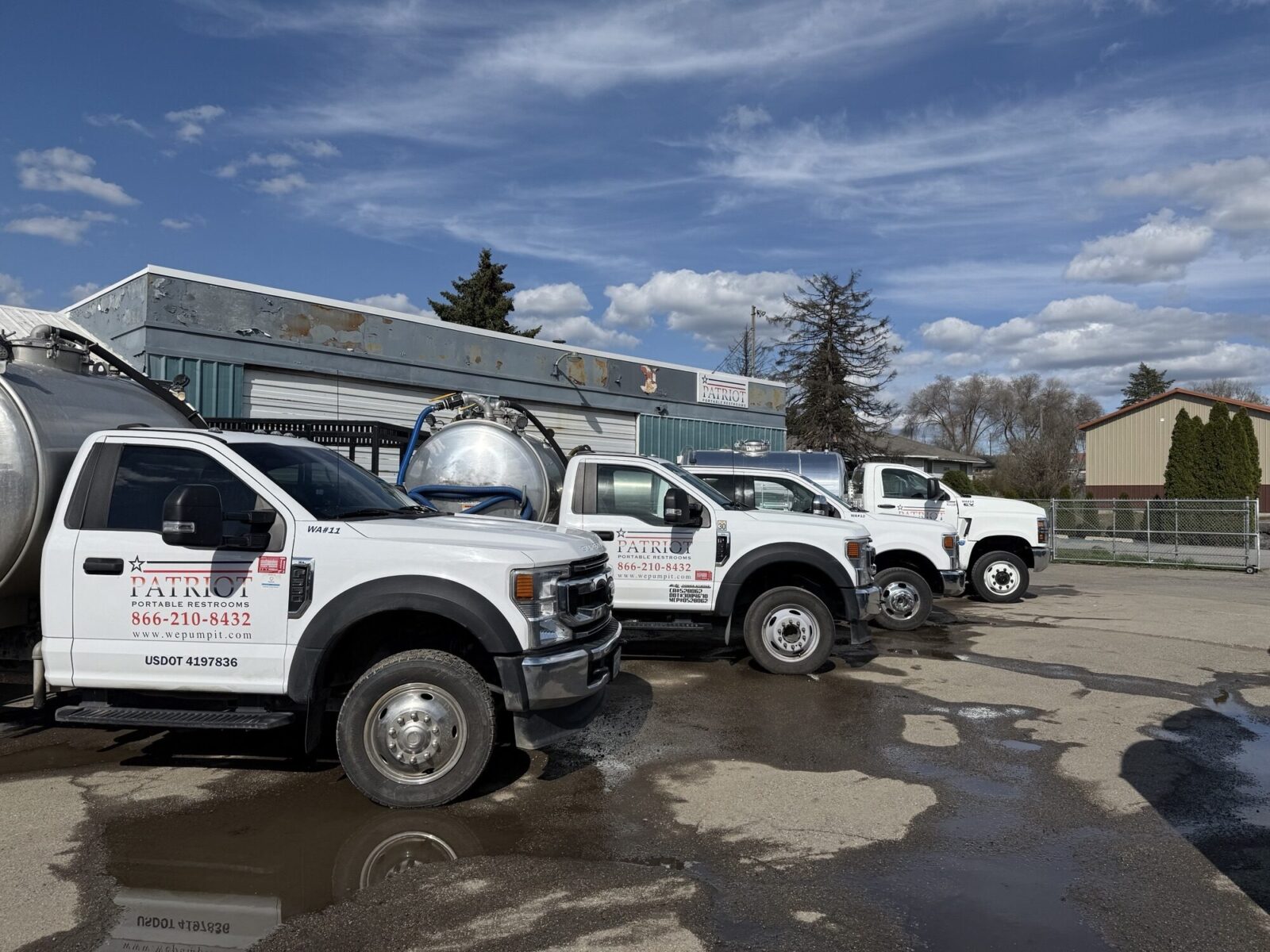 A picture of a fleet of our pump trucks at our portable restroom yard in Spokane, WA.