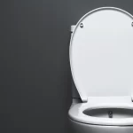 Clean white toilet seat inside a modern restroom showing sanitation and hygiene standards